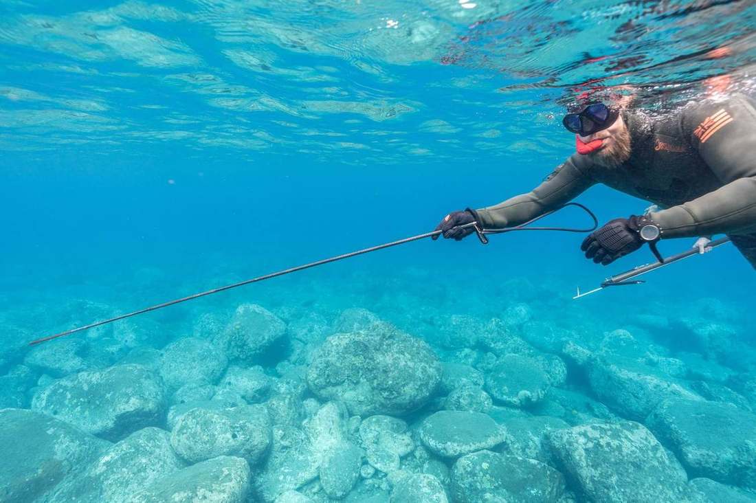 Guided spearfishing dive over a shallow Kona reef